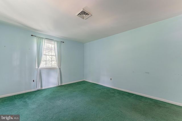 a patio with glass top table and chairs