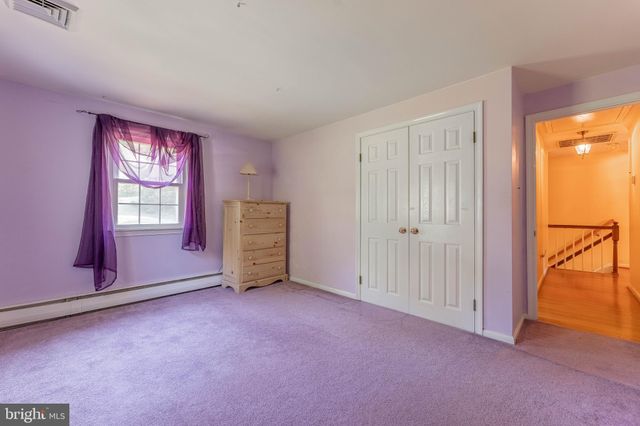a view of yard with swimming pool and trees in the background