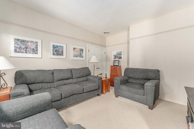 a view of a dining room with furniture wooden floor and a chandelier
