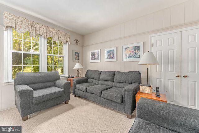 a view of a dining room with furniture wooden floor and chandelier