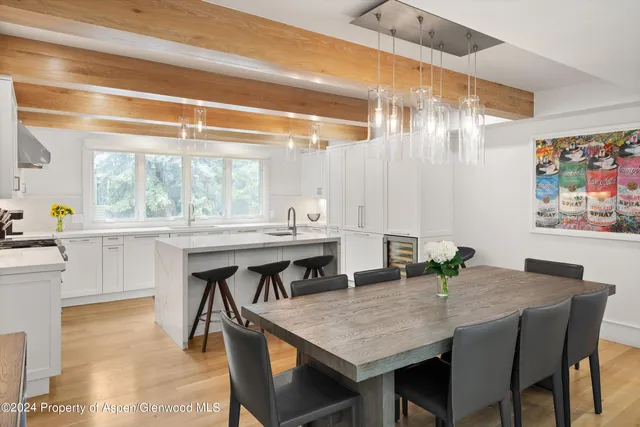a dining table with chairs and window