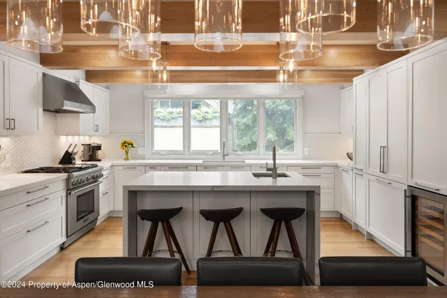 a kitchen with stainless steel appliances granite countertop a stove a sink and a refrigerator