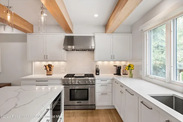 a kitchen with a stove a sink and a microwave