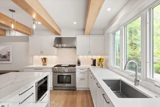 a kitchen with stainless steel appliances a stove sink and cabinets