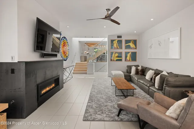 a living room with furniture and a fireplace