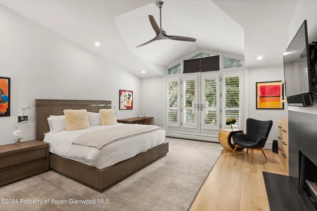 a bedroom with a fireplace television and a couch