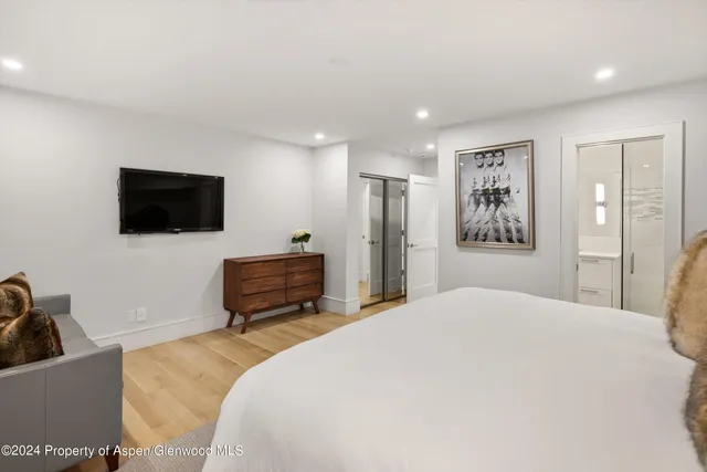 a bedroom with a bed couch and window