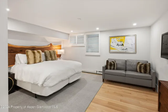 a bathroom with a sink vanity granite tub shower and mirror