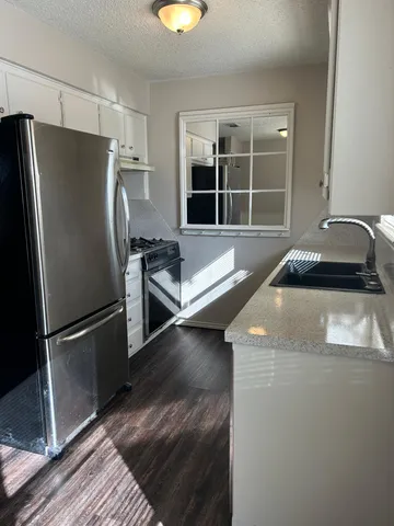 a kitchen with a refrigerator and countertop