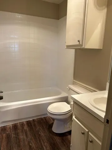 a bathroom with a toilet a sink and bathtub
