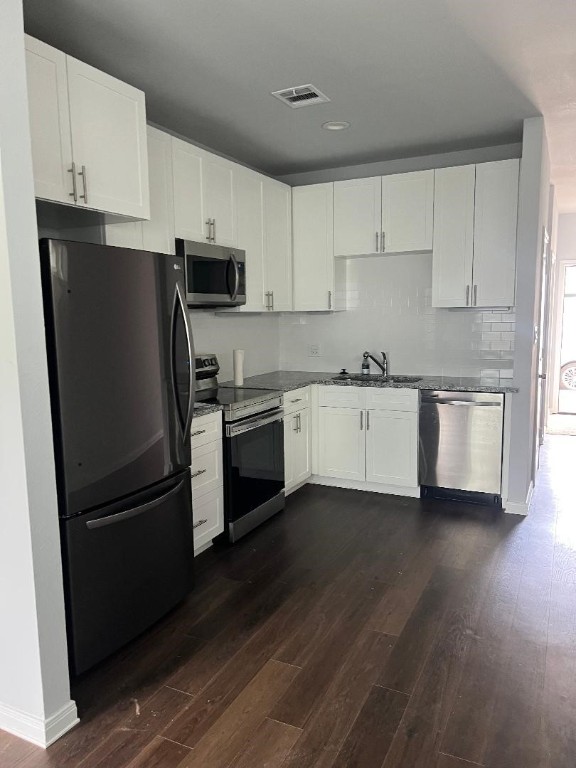 18817 Luminescent Ln Spring Spring, TX 77379 - Photo 2 of 15 a kitchen with cabinets stainless steel appliances a sink and wooden floor