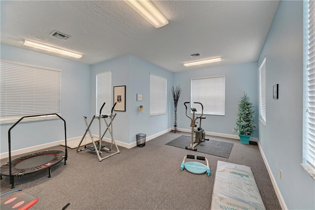 8171 Hampton Wood Drive Boca Raton, FL 33433 - Photo 49 of 56 a view of a room with gym equipment