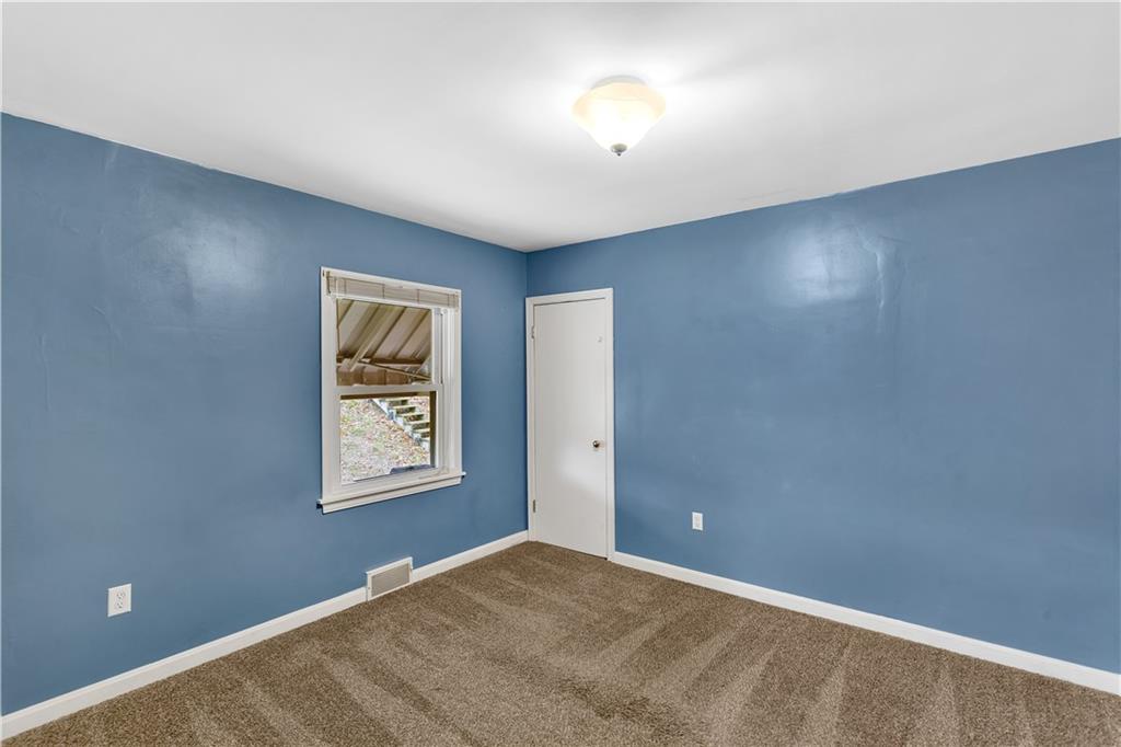 1710 Ridge Rd Extension Ambridge, PA 15003 - Photo 11 of 31 an empty room with windows and closet