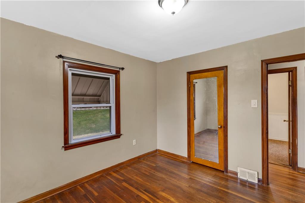 1710 Ridge Rd Extension Ambridge, PA 15003 - Photo 15 of 31 an empty room with wooden floor mirror and windows