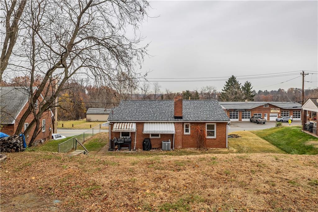 1710 Ridge Rd Extension Ambridge, PA 15003 - Photo 27 of 31 a front view of a house with a yard and garage