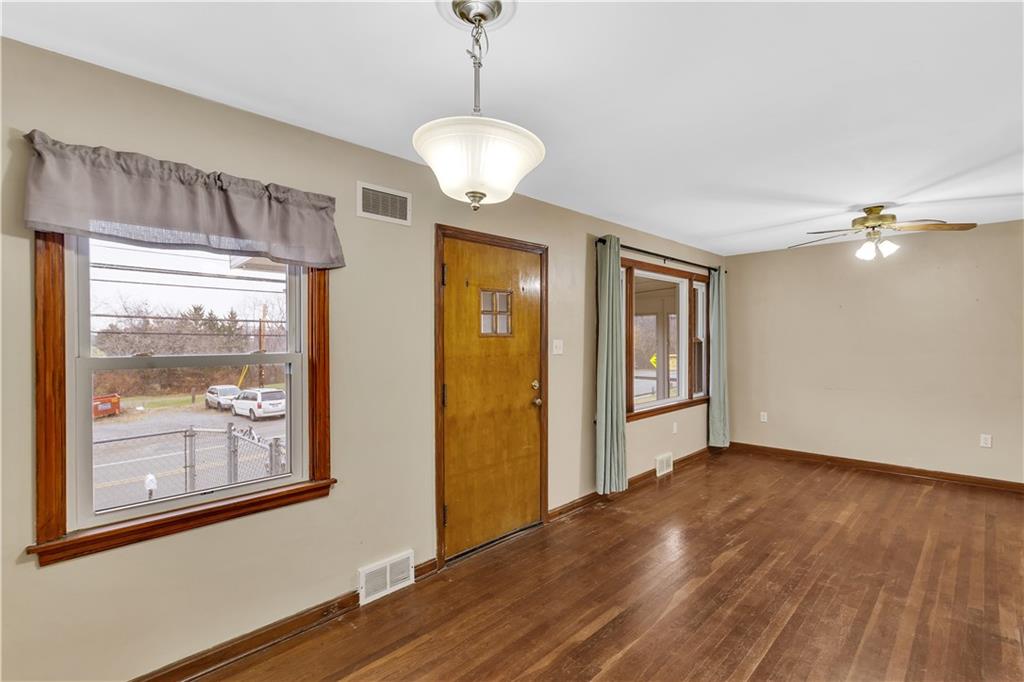 1710 Ridge Rd Extension Ambridge, PA 15003 - Photo 6 of 31 a view of an empty room with wooden floor and a window