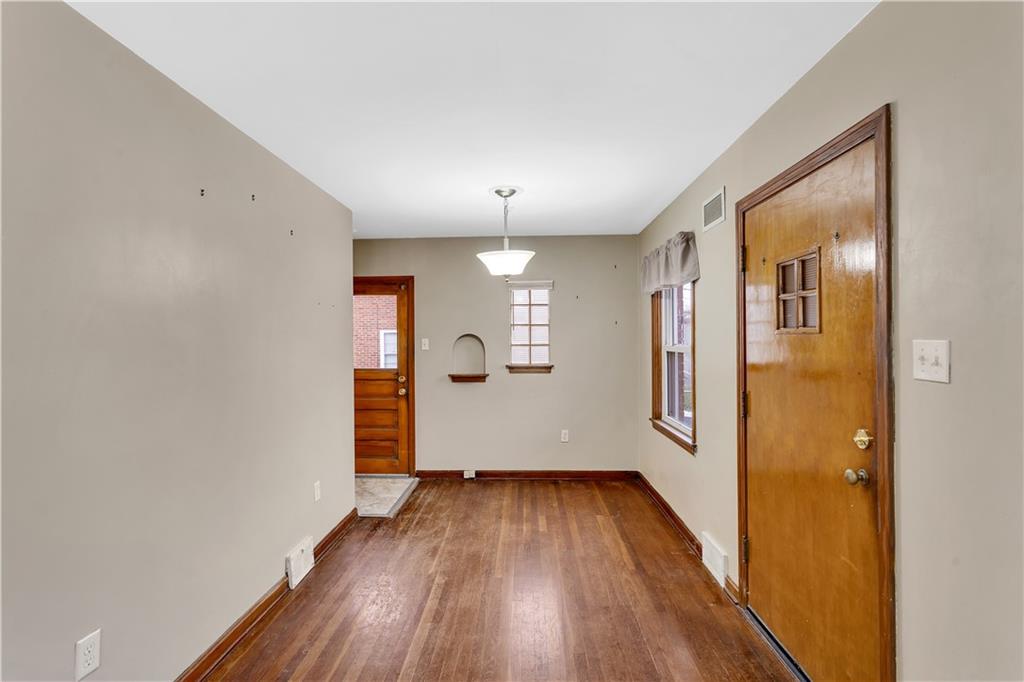 1710 Ridge Rd Extension Ambridge, PA 15003 - Photo 8 of 31 wooden floor in an empty room with a window