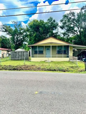 a front view of a house with a garden and yard