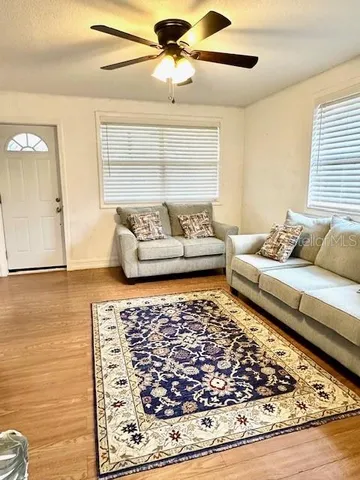 a living room with rug and a flat screen tv