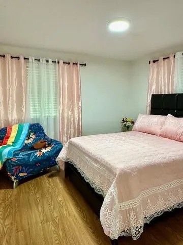 a view of an empty room with cabinet and mirrors