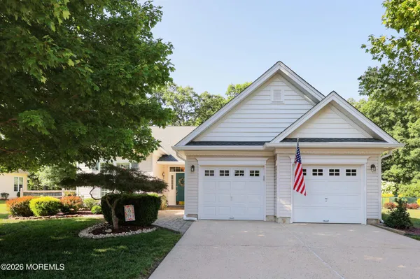 a view of a house with a yard and a garage
