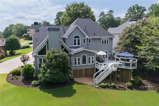 an aerial view of a house with swimming pool and garden
