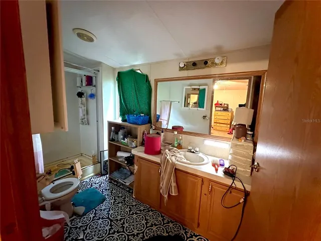 a bedroom with bed and a chandelier