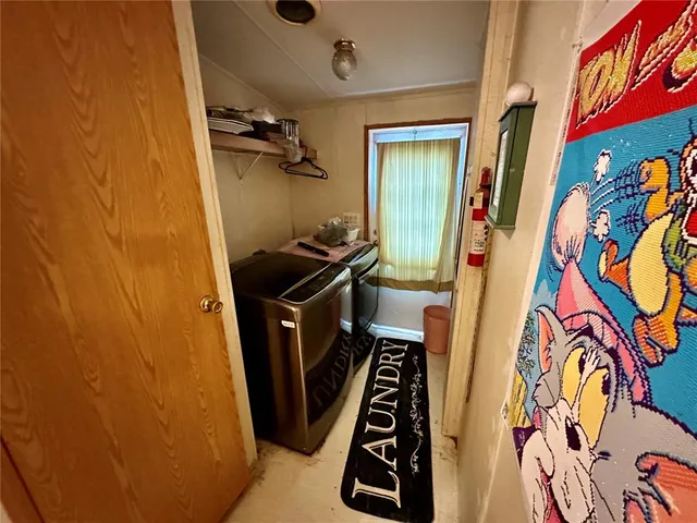 an aerial view of a house with a yard and large trees