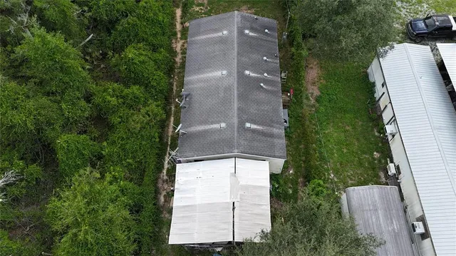 an aerial view of a house with a yard