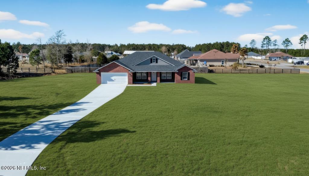 55225 Bartram Trail Callahan, FL 32011 - Photo 1 of 69 a view of a big house with a big yard and large tree