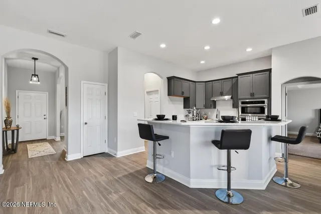 a living room with furniture a window and a potted plant