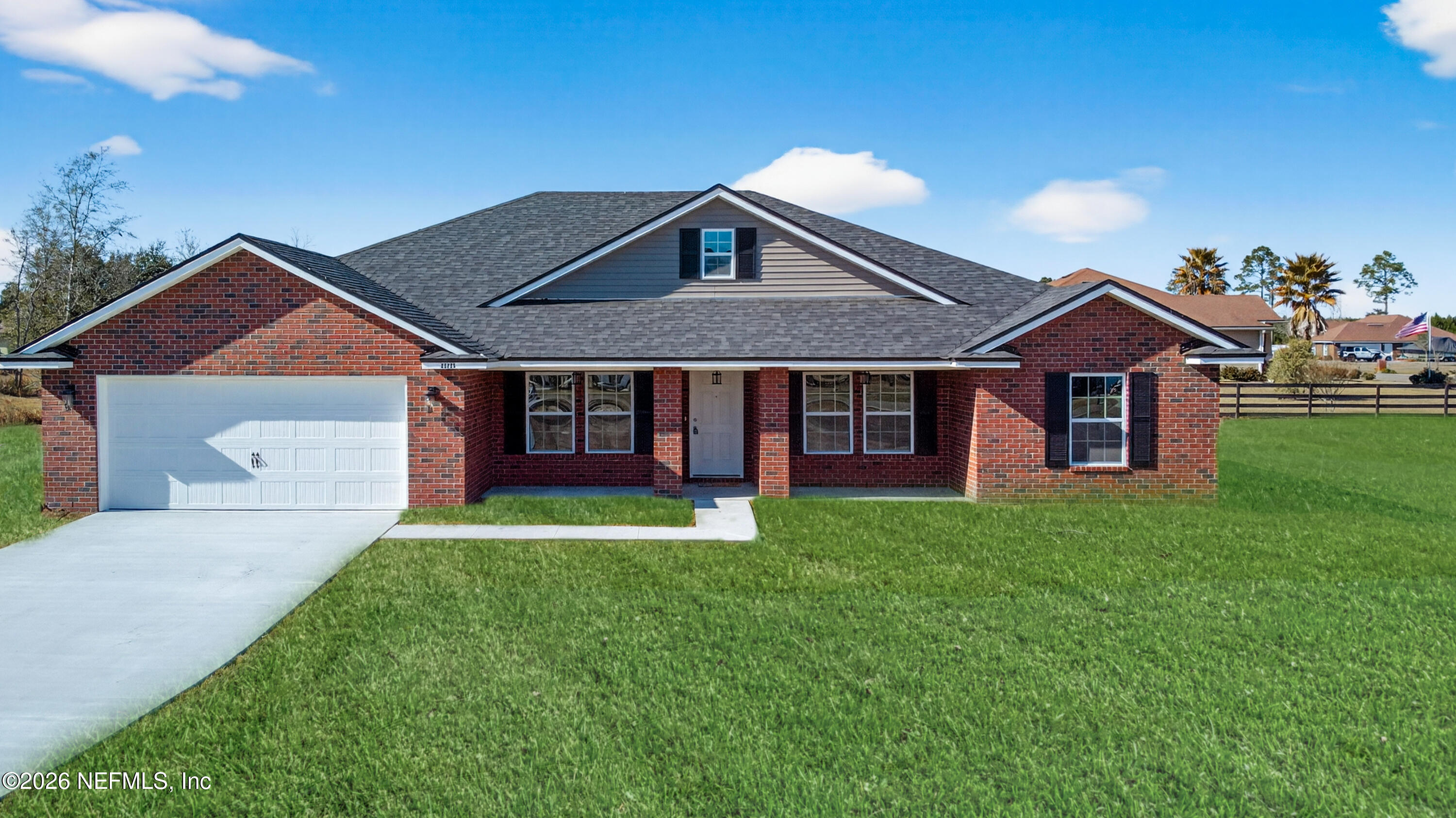 55225 Bartram Trail Callahan, FL 32011 - Photo 2 of 69 a front view of a house with a garden and yard