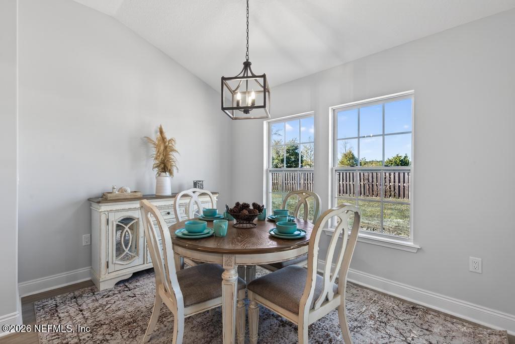 55225 Bartram Trail Callahan, FL 32011 - Photo 23 of 69 a view of a dining room with furniture window and outside view