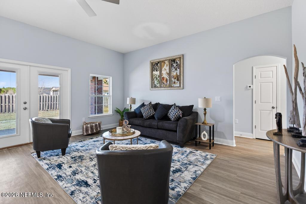 55225 Bartram Trail Callahan, FL 32011 - Photo 27 of 69 a living room with furniture a large window and wood floor