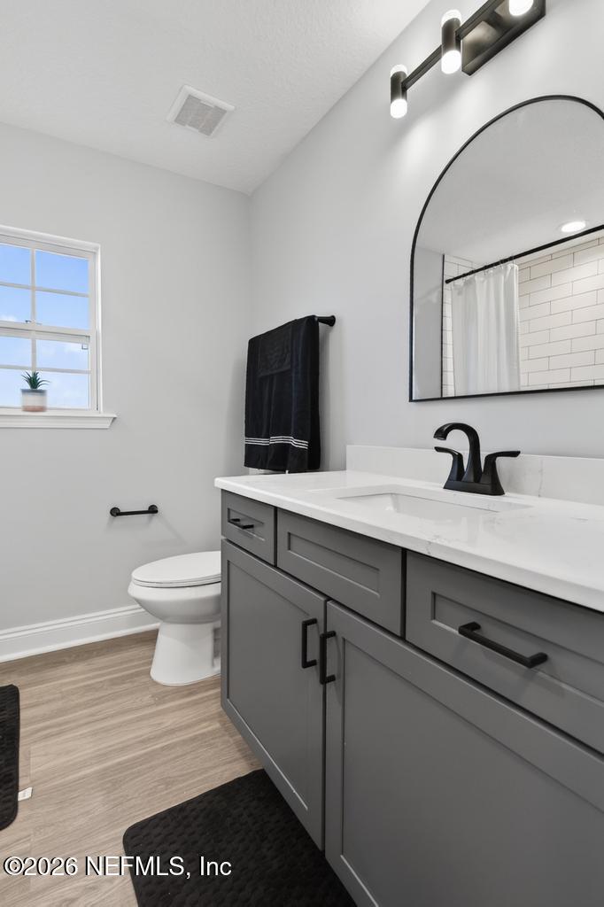 55225 Bartram Trail Callahan, FL 32011 - Photo 35 of 69 a bathroom with a sink a toilet and mirror