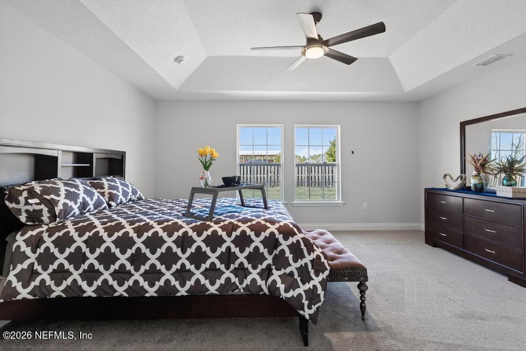 55225 Bartram Trail Callahan, FL 32011 - Photo 43 of 69 a bedroom with a bed and dresser