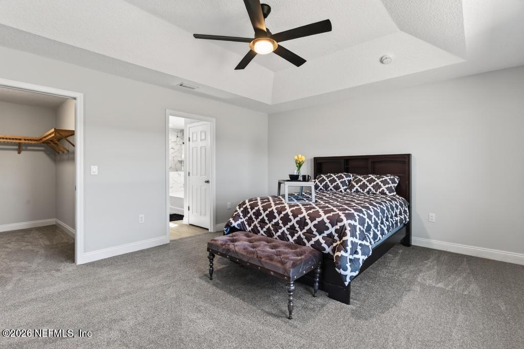 55225 Bartram Trail Callahan, FL 32011 - Photo 45 of 69 a bedroom with a bed and a ceiling fan