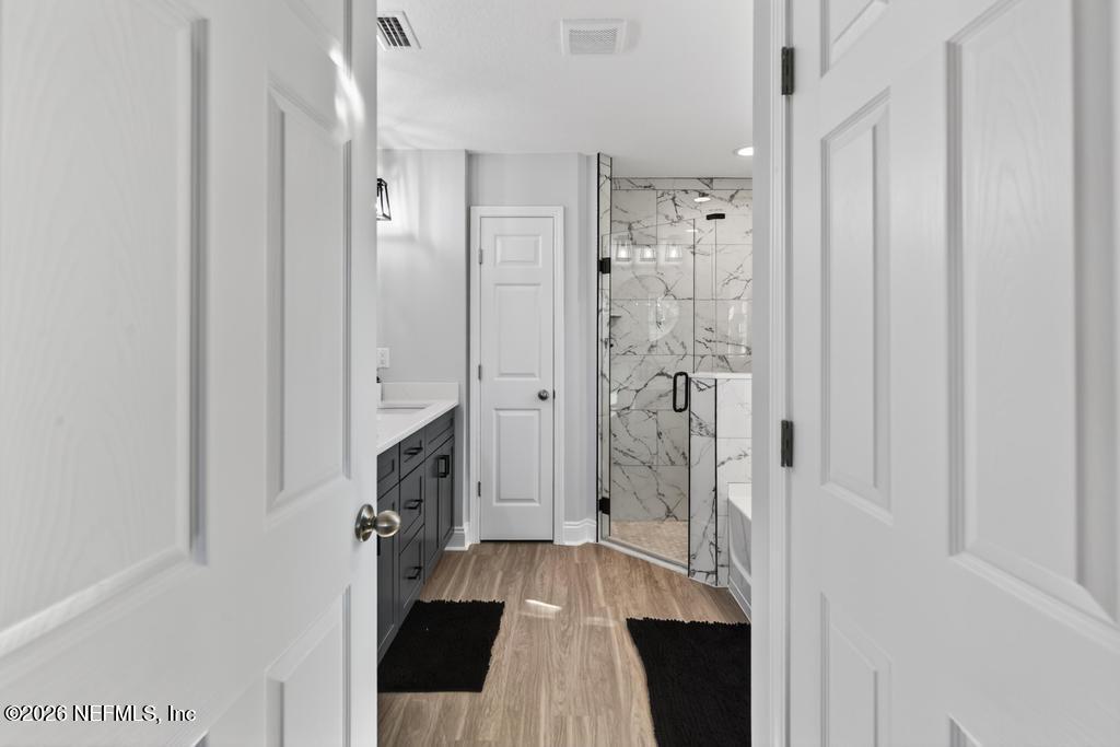 55225 Bartram Trail Callahan, FL 32011 - Photo 49 of 69 a spacious bathroom with a sink and glass door shower