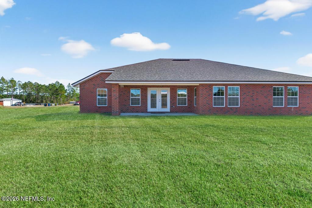 55225 Bartram Trail Callahan, FL 32011 - Photo 58 of 69 a view of a brick house with a yard