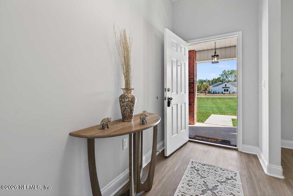 55225 Bartram Trail Callahan, FL 32011 - Photo 9 of 69 a view of hallway with furniture and a window