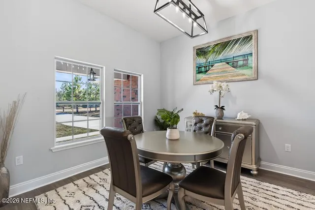 a dining room with furniture and wooden floor