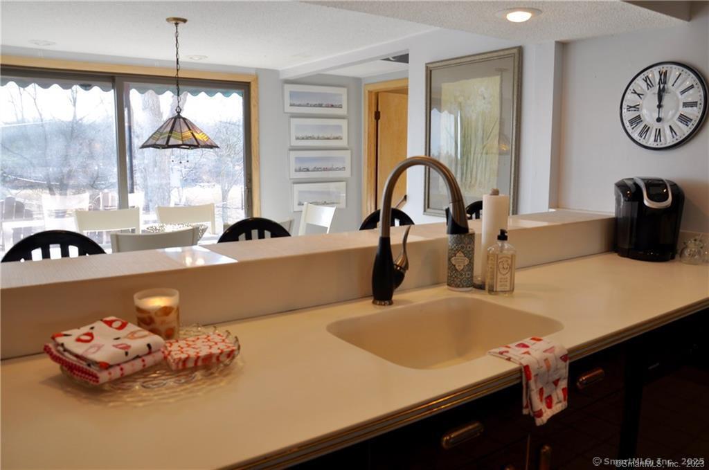 92 High Ridge Road, Unit JUNE 2026 2 Guilford, CT 06437 - Photo 11 of 33 a kitchen with a table chairs and a window