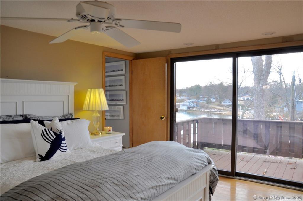 92 High Ridge Road, Unit JUNE 2026 2 Guilford, CT 06437 - Photo 18 of 33 a bedroom with a bed and large window