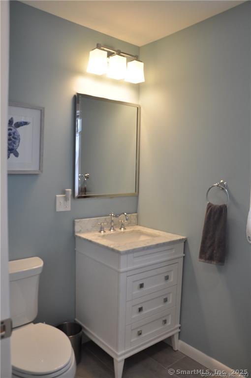 92 High Ridge Road, Unit JUNE 2026 2 Guilford, CT 06437 - Photo 19 of 33 a bathroom with a toilet sink and mirror