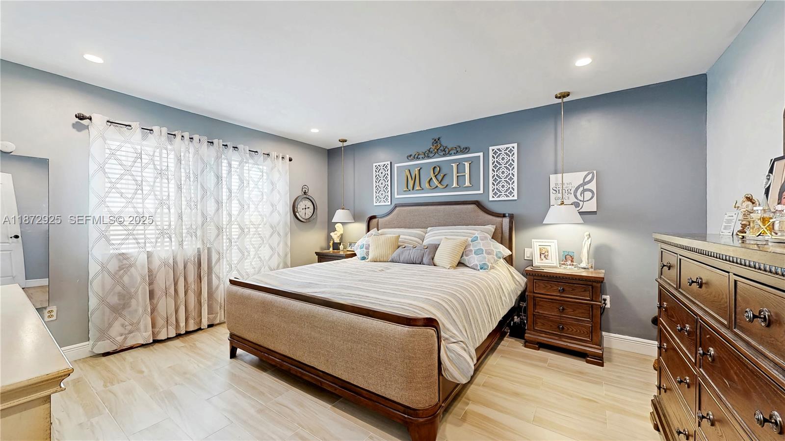 982 Northwest 133rd Court Miami, FL 33182 - Photo 13 of 22 a bedroom with a bed and a chandelier