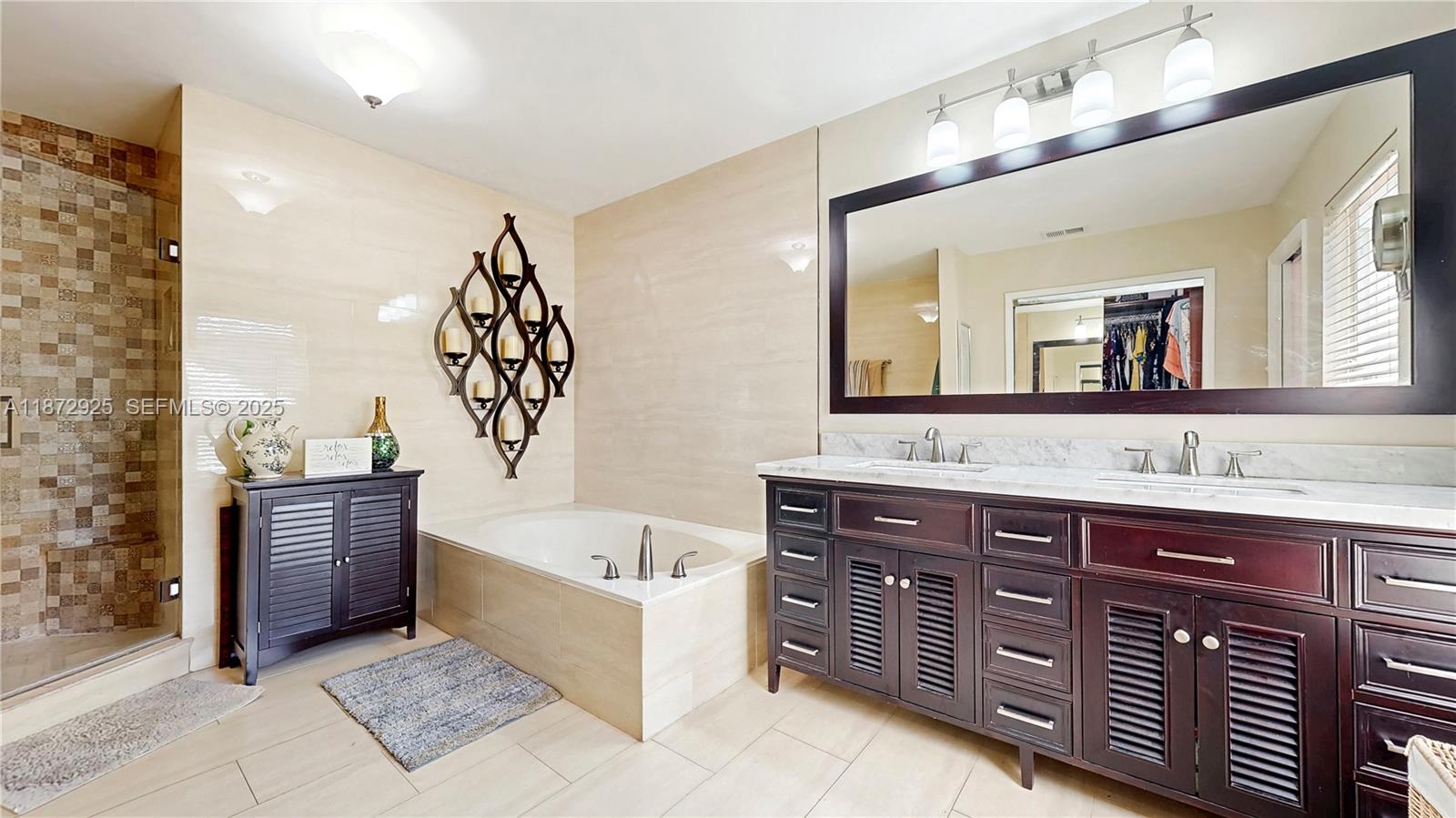 982 Northwest 133rd Court Miami, FL 33182 - Photo 14 of 22 a bathroom with a tub sink and mirror