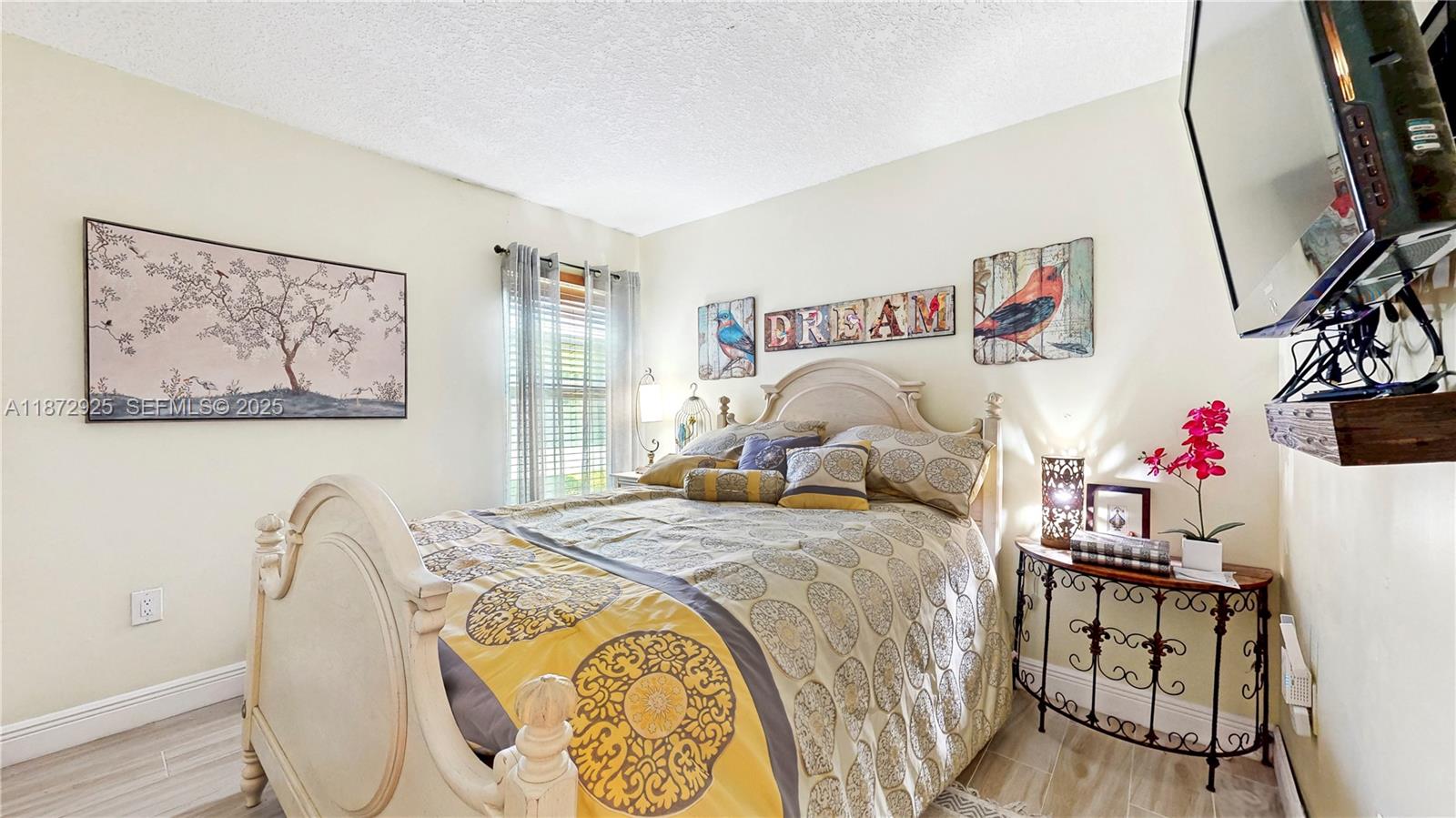 982 Northwest 133rd Court Miami, FL 33182 - Photo 16 of 22 a bedroom with a bed and a table in it