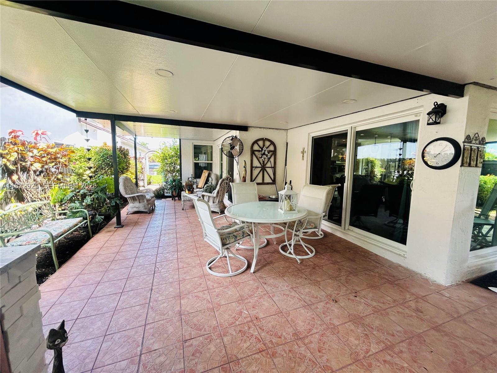 982 Northwest 133rd Court Miami, FL 33182 - Photo 18 of 22 a view of a chairs and table in a patio