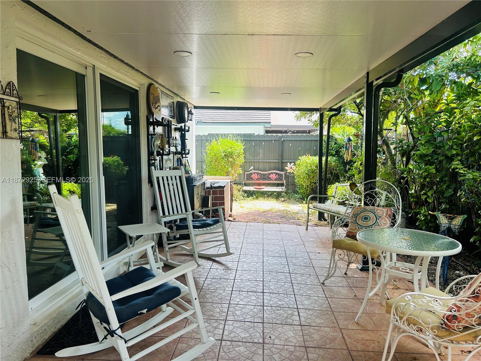 982 Northwest 133rd Court Miami, FL 33182 - Photo 21 of 22 a view of a patio with dining table and chairs