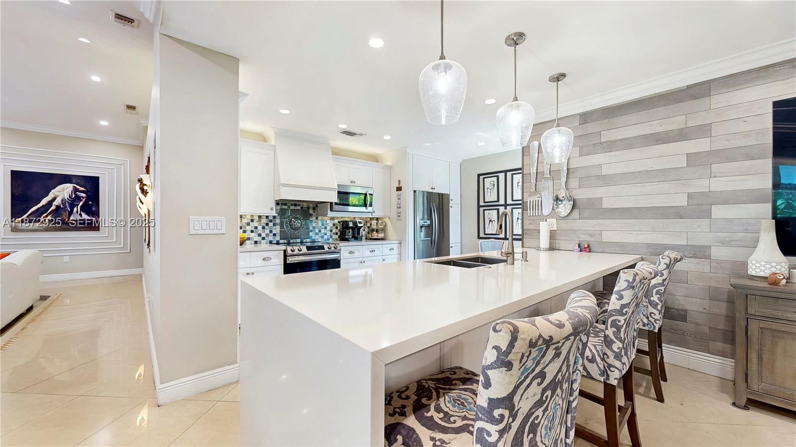 982 Northwest 133rd Court Miami, FL 33182 - Photo 8 of 22 a kitchen with granite countertop a table and chairs